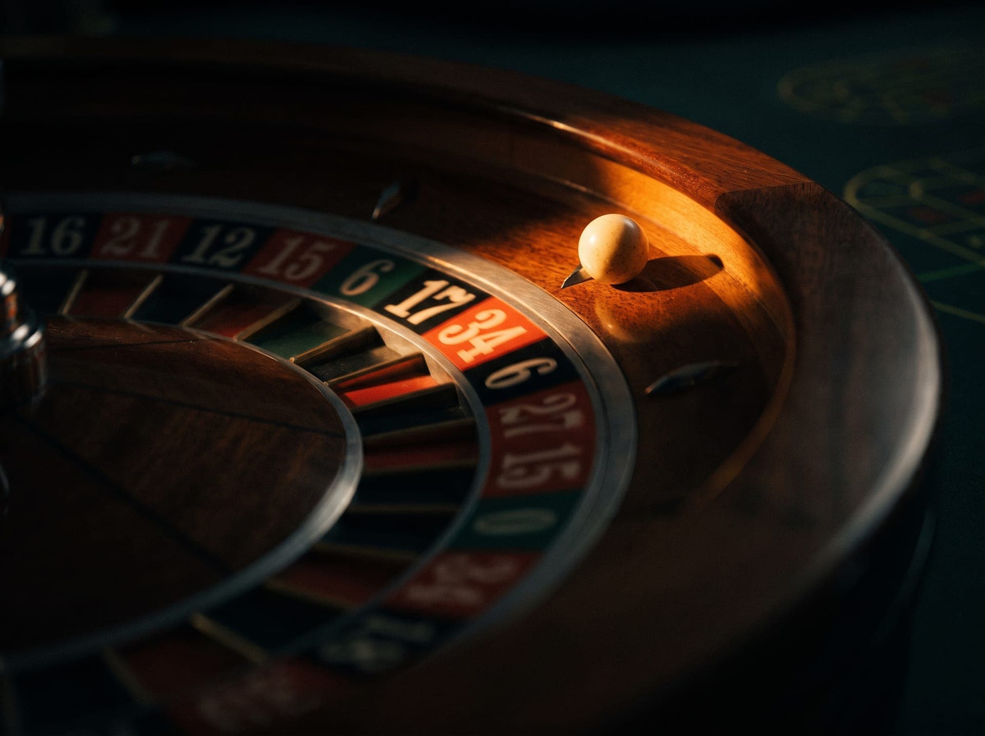Roulette wheel in a warm beam of light in the dark